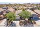 Overhead view of a residential neighborhood featuring tree-lined streets and mountain views in the distance at 85 W Grey Stone St, San Tan Valley, AZ 85143