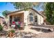 Relaxing backyard patio featuring a covered seating area, dining set, desert landscaping, and mature shade trees at 85 W Grey Stone St, San Tan Valley, AZ 85143