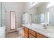 Bright bathroom with double sinks, tile flooring, walk-in shower and a separate bathtub at 85 W Grey Stone St, San Tan Valley, AZ 85143