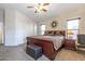 Comfortable bedroom featuring a ceiling fan, neutral walls, plush carpeting, and a large wooden bed frame at 85 W Grey Stone St, San Tan Valley, AZ 85143