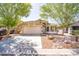 Inviting single-story home boasting desert landscaping, mature shade trees, and a two-car garage at 85 W Grey Stone St, San Tan Valley, AZ 85143