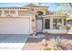 Charming single-story home featuring a desert landscape, a two-car garage, and a tiled roof at 85 W Grey Stone St, San Tan Valley, AZ 85143