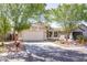 Charming single-Gathering home featuring a xeriscaped front yard and mature trees enhancing curb appeal at 85 W Grey Stone St, San Tan Valley, AZ 85143
