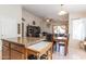 Open-concept kitchen featuring a granite island with seating, and seamlessly connected to the living area at 85 W Grey Stone St, San Tan Valley, AZ 85143