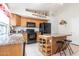 Well-appointed kitchen featuring granite countertops, black appliances, and an inviting center island with seating at 85 W Grey Stone St, San Tan Valley, AZ 85143