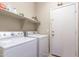 Convenient laundry room featuring a washer, dryer, and storage shelving, for streamlined chores at 85 W Grey Stone St, San Tan Valley, AZ 85143