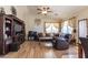 Comfortable living room with hardwood floors, a ceiling fan, and a large window for natural light at 85 W Grey Stone St, San Tan Valley, AZ 85143
