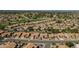 Expansive aerial view of a residential neighborhood adjacent to a golf course and rolling hills at 9130 W Rimrock Dr, Peoria, AZ 85382