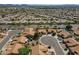 Wide aerial view of a neighborhood featuring well-maintained homes, streets, and desert landscaping at 9130 W Rimrock Dr, Peoria, AZ 85382