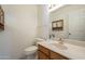 A powder room with a light marble countertop, white toilet, and simple decorations at 9130 W Rimrock Dr, Peoria, AZ 85382