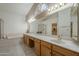 The primary bathroom has dual vanities and a tub next to the glass enclosed shower at 9130 W Rimrock Dr, Peoria, AZ 85382