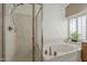 A soaking tub with jets is next to a glass-enclosed shower for luxury at 9130 W Rimrock Dr, Peoria, AZ 85382