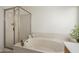 The soaking tub boasts a glass enclosed shower and jets for relaxation at 9130 W Rimrock Dr, Peoria, AZ 85382