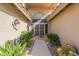 Covered entryway features a tiled walkway and mature desert landscaping at 9130 W Rimrock Dr, Peoria, AZ 85382