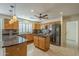 The kitchen features stainless steel appliances, a center island and stone countertops at 9130 W Rimrock Dr, Peoria, AZ 85382