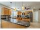 An eat-in kitchen offers granite countertops, stainless steel appliances, and lovely wooden cabinets at 9130 W Rimrock Dr, Peoria, AZ 85382