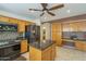 Well-equipped kitchen featuring wood cabinets, granite counters, stainless steel appliances and breakfast bar at 9130 W Rimrock Dr, Peoria, AZ 85382