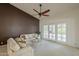 The living room boasts neutral walls, plush carpeting, and stylish furniture at 9130 W Rimrock Dr, Peoria, AZ 85382