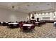 Elegant meeting room featuring round tables with burgundy chairs, stylish lighting, and neutral walls at 9130 W Rimrock Dr, Peoria, AZ 85382