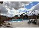 Inviting community pool area with lounge chairs, palm trees, and a relaxing atmosphere at 9130 W Rimrock Dr, Peoria, AZ 85382