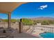 Balcony view with sculpture overlooking pool and desert landscape at 9736 E Sleepy Hollow Trl, Gold Canyon, AZ 85118