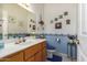 Charming bathroom featuring a wooden vanity, soft blue accents, and decorated walls at 9736 E Sleepy Hollow Trl, Gold Canyon, AZ 85118
