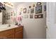 Half bath features a wood vanity, decor, and great natural light at 9736 E Sleepy Hollow Trl, Gold Canyon, AZ 85118