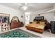 Spacious bedroom featuring tile floors, a ceiling fan, and a full dresser set at 9736 E Sleepy Hollow Trl, Gold Canyon, AZ 85118