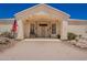 Close up view of the entryway featuring a covered porch, bench seating, and desert landscaping at 9736 E Sleepy Hollow Trl, Gold Canyon, AZ 85118