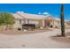 Front view of single-story home with desert landscaping, covered entryway, and a vintage wagon on the property at 9736 E Sleepy Hollow Trl, Gold Canyon, AZ 85118