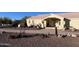 Charming single-story home with decorative wagon and desert landscaping at 9736 E Sleepy Hollow Trl, Gold Canyon, AZ 85118