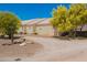 Side view of single-story home with desert landscaping, bright green trees, and mountain views at 9736 E Sleepy Hollow Trl, Gold Canyon, AZ 85118