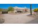 Side view of single-story home with desert landscaping, covered entryway, and a vintage wagon on the property at 9736 E Sleepy Hollow Trl, Gold Canyon, AZ 85118