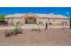 Wide front view of a well-maintained single-story house with desert landscaping and covered entryway at 9736 E Sleepy Hollow Trl, Gold Canyon, AZ 85118