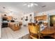 Large kitchen and dining area offering tile floors, an island, and wood cabinets at 9736 E Sleepy Hollow Trl, Gold Canyon, AZ 85118