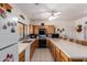 Bright kitchen offers plenty of counterspace, wood cabinets, and an eat-in island at 9736 E Sleepy Hollow Trl, Gold Canyon, AZ 85118