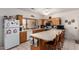Bright kitchen features plenty of counterspace, wood cabinets, and an eat-in island at 9736 E Sleepy Hollow Trl, Gold Canyon, AZ 85118