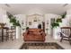 Open living room with large leather sofa, high ceilings, and plant decor at 9736 E Sleepy Hollow Trl, Gold Canyon, AZ 85118