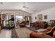 Spacious living room with high ceilings, tile floors, leather furniture, and a treadmill at 9736 E Sleepy Hollow Trl, Gold Canyon, AZ 85118