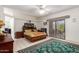 Bright main bedroom featuring an outdoor access, ceiling fan, and ensuite bathroom at 9736 E Sleepy Hollow Trl, Gold Canyon, AZ 85118