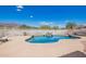 Inviting pool area with rock waterfall feature and desert views at 9736 E Sleepy Hollow Trl, Gold Canyon, AZ 85118