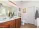 Well-lit bathroom with double sink vanity, tile floors, and a large mirror at 10037 W Watkins St, Tolleson, AZ 85353