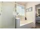 Bright bathroom featuring a glass-enclosed shower, soaking tub, and tasteful decor at 10037 W Watkins St, Tolleson, AZ 85353