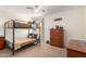 Comfortable bedroom with a bunk bed, ceiling fan, and ample natural light at 10037 W Watkins St, Tolleson, AZ 85353