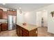 Well-equipped kitchen with center island, stainless steel appliances, and tiled flooring at 10037 W Watkins St, Tolleson, AZ 85353