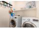 Efficient laundry room with modern washer and dryer and ample storage space at 10037 W Watkins St, Tolleson, AZ 85353