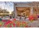 Relaxing outdoor patio area with seating, desert landscaping and colorful flowers at 10067 E Santa Catalina Dr, Scottsdale, AZ 85255