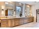 Modern bathroom features double sinks, custom cabinets, and framed mirrors at 10067 E Santa Catalina Dr, Scottsdale, AZ 85255