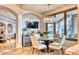 Inviting dining area featuring contemporary lighting and window views to the backyard at 10067 E Santa Catalina Dr, Scottsdale, AZ 85255