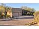 Paver driveway leading to a two-car garage surrounded by desert landscaping at 10067 E Santa Catalina Dr, Scottsdale, AZ 85255